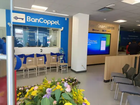 Sucursal BanCoppel: ventanillas con moños azules y arreglo floral